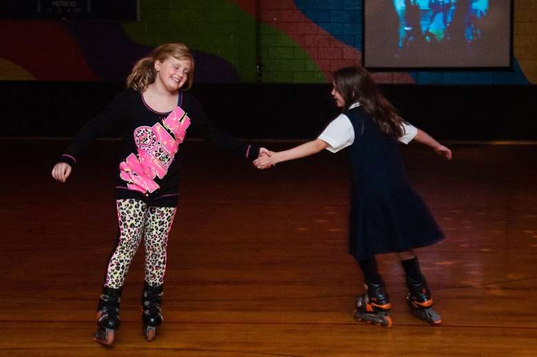 two girls skating together