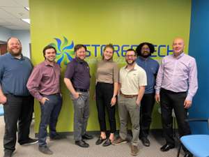 employees pose together