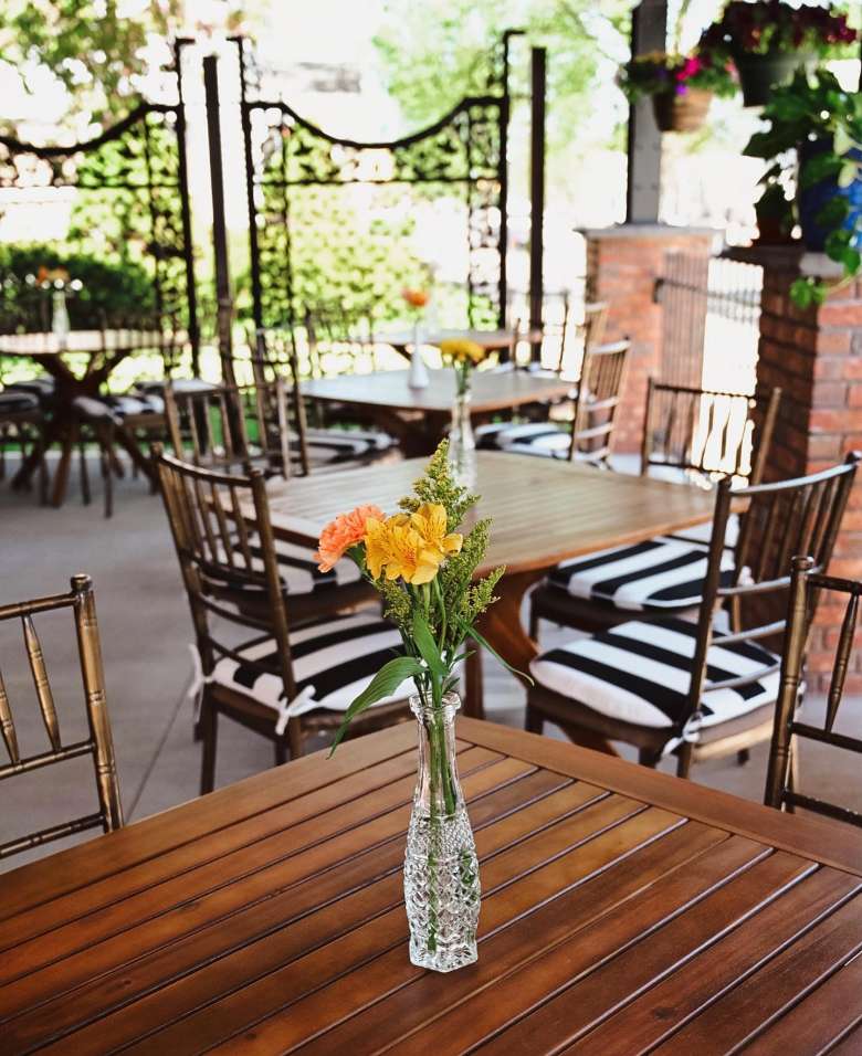 flower centerpiece on outdoor table.