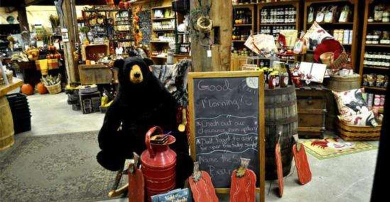 interior of the silo country store with a stuffed black bear, a welcome sign, and shelves full of preserves