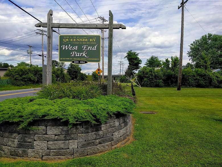 the sign for West End Park on a stone flowerbed