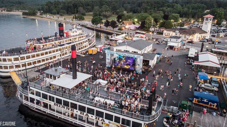 aerial view of rock the dock music festival on a pier surrounded by three large steamboats