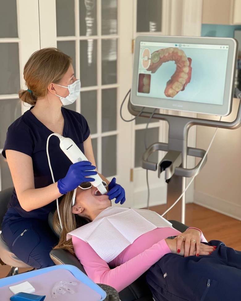 orthodontist looking at screen while using machine