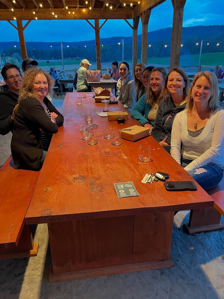 group of people seated outdoors at a patio table
