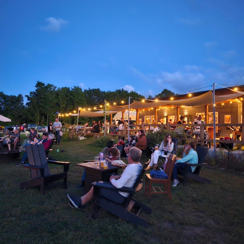 people seated outdoors on brewery pati