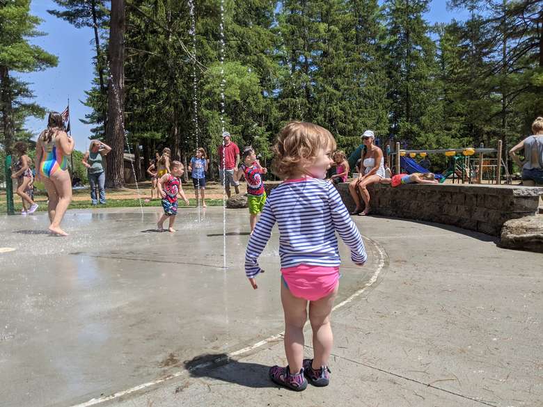 toddler at splash pad