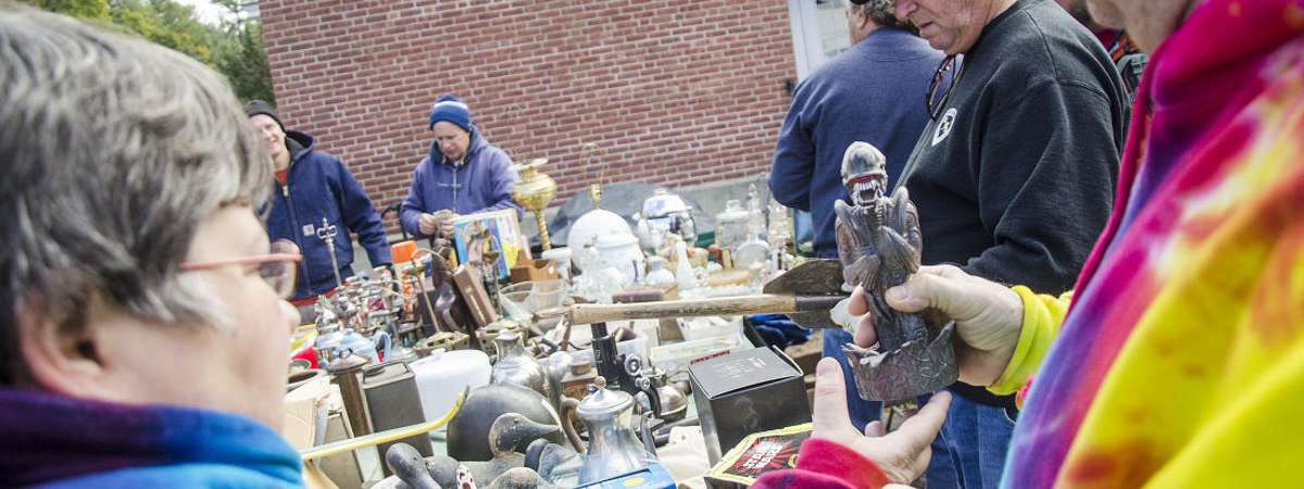 vintage collectibles on tables at garage sale