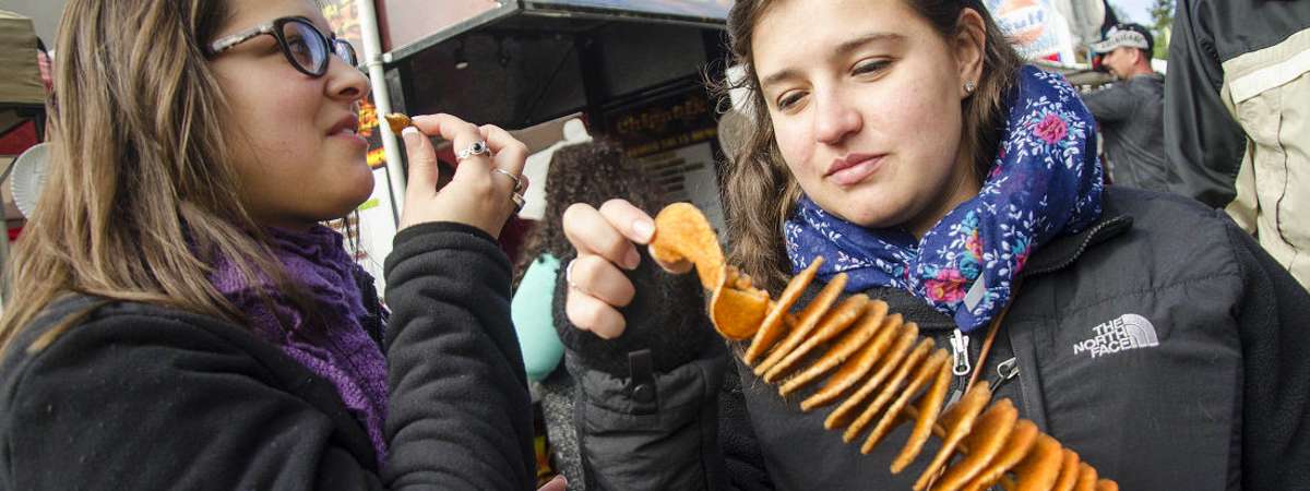 woman holding stick of snacks