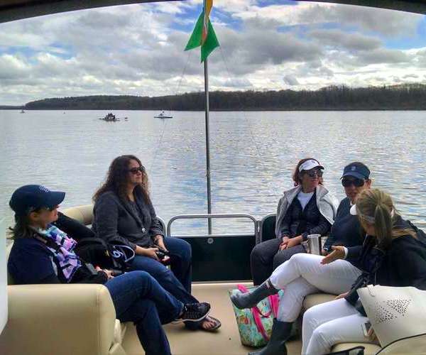 Adirondack charter on the lake with an American flag.