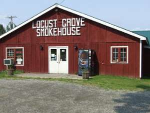 exterior of red barn with locust grove smokehouse in white letters