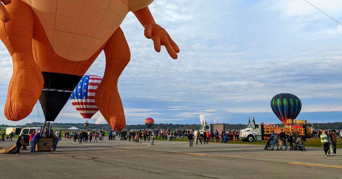 part of a tazmanian devil hot air balloon and crowds at balloon festival