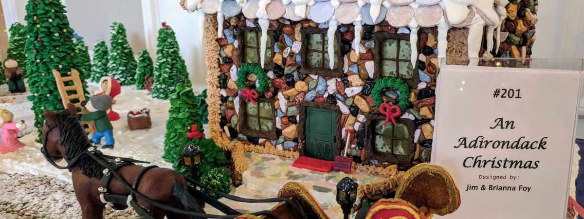 gingerbread house with sign that says adirondack christmas