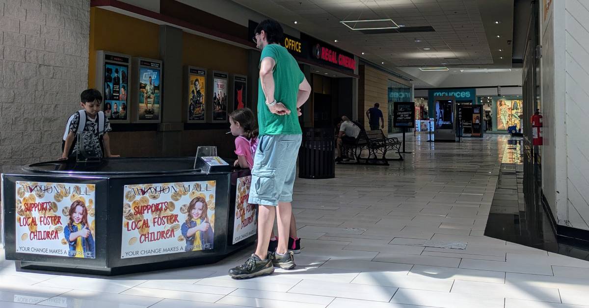 family inside aviation mall near movie theater
