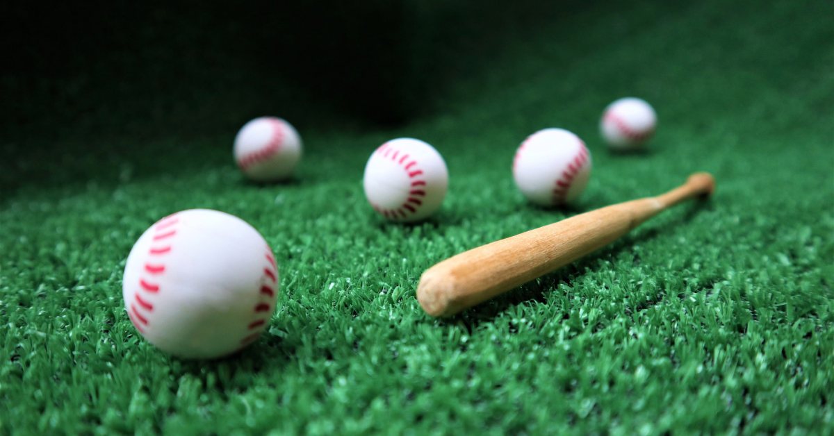 five baseballs and a bat