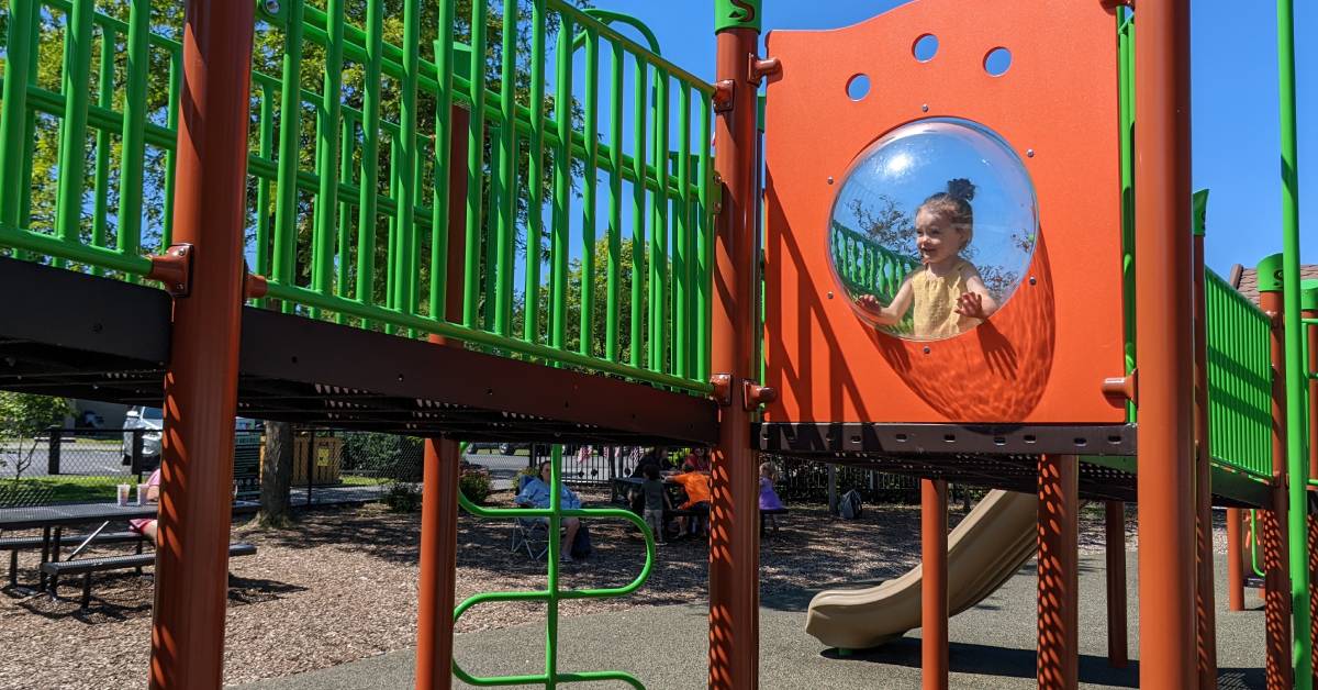 little girl on playground at hovey pond park