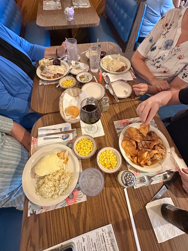 plated food and people at table