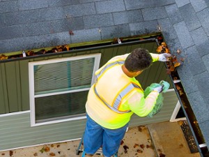man cleaning out gutters