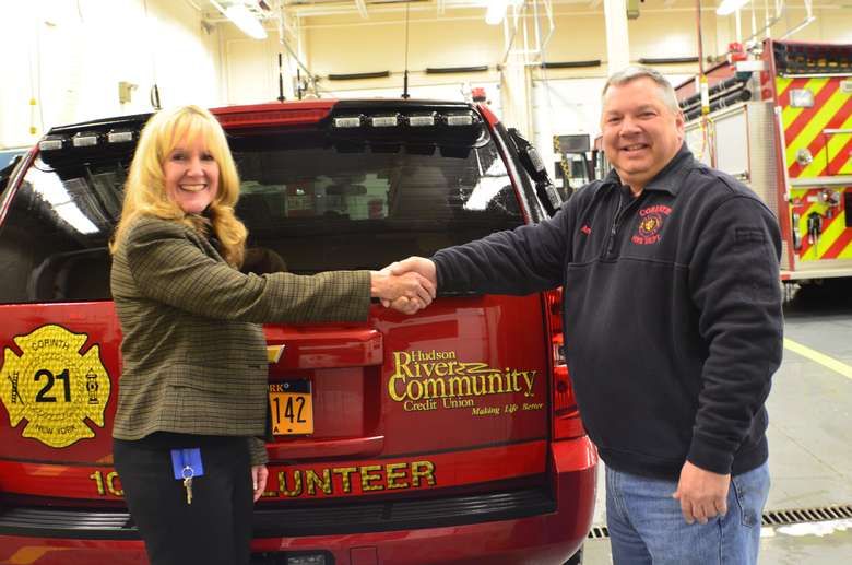 Woman shaking hands at firehouse