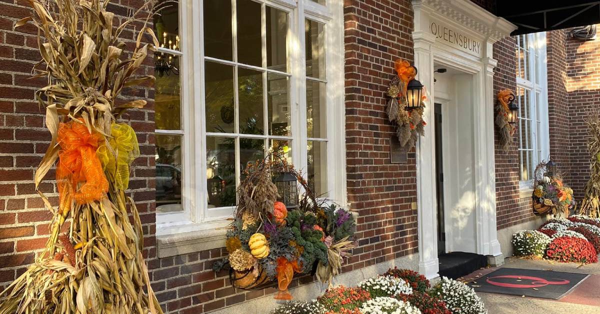 exterior of queensbury hotel entrance decked out for fall