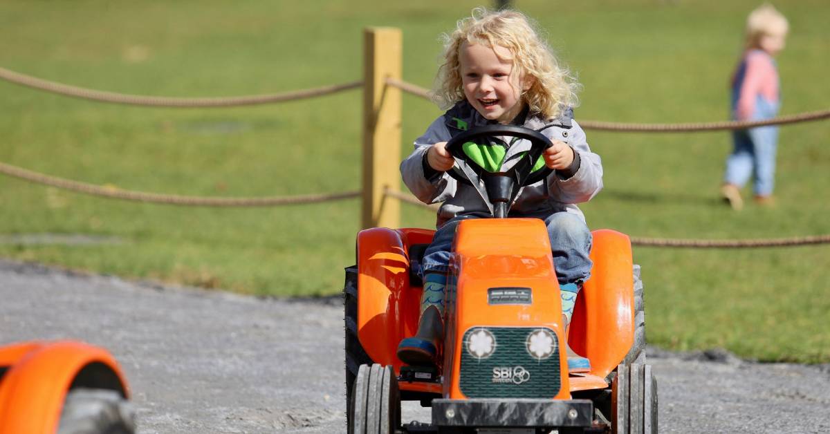 little kid on little tractor