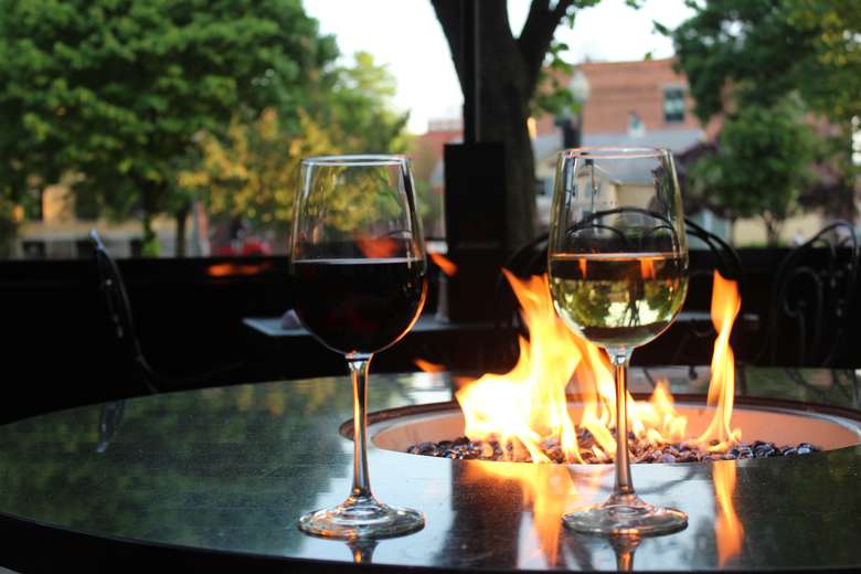 Two wine glasses in front of fire
