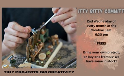 A pair of hands working to build a miniature scene