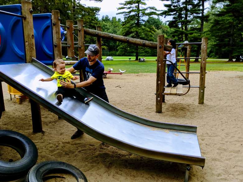 dad with kid on slide