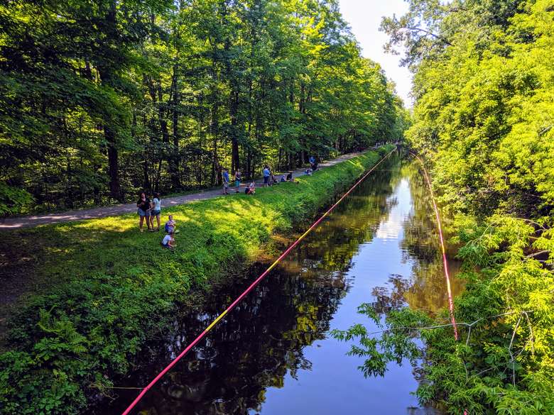 people standing by a canal