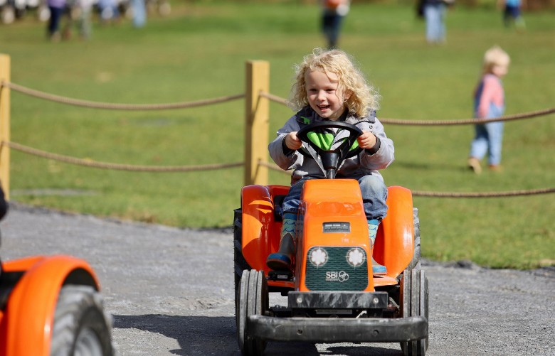 little kid on mini tractor