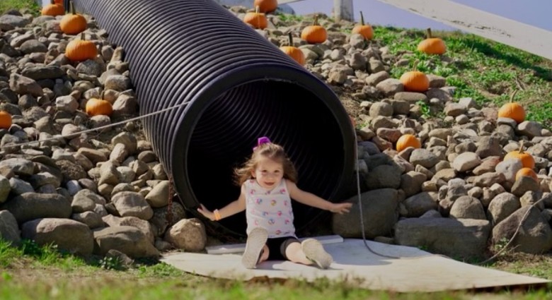 girl comes out of tunnel slide
