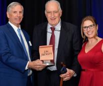 three people, one holding jw juckett award