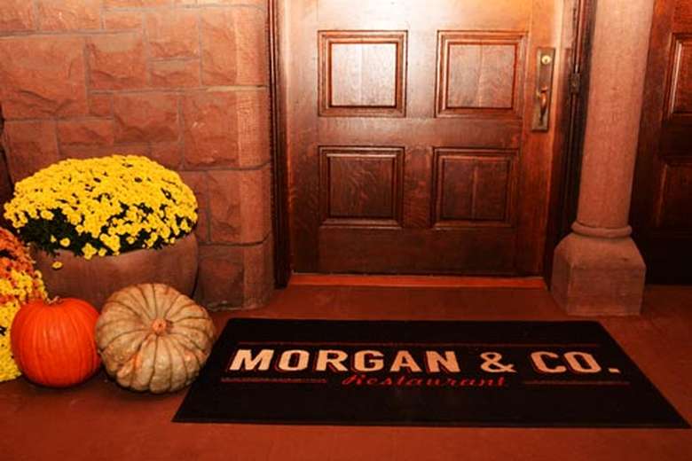 door with flowers, pumpkins, and mat that says Morgan & Co.