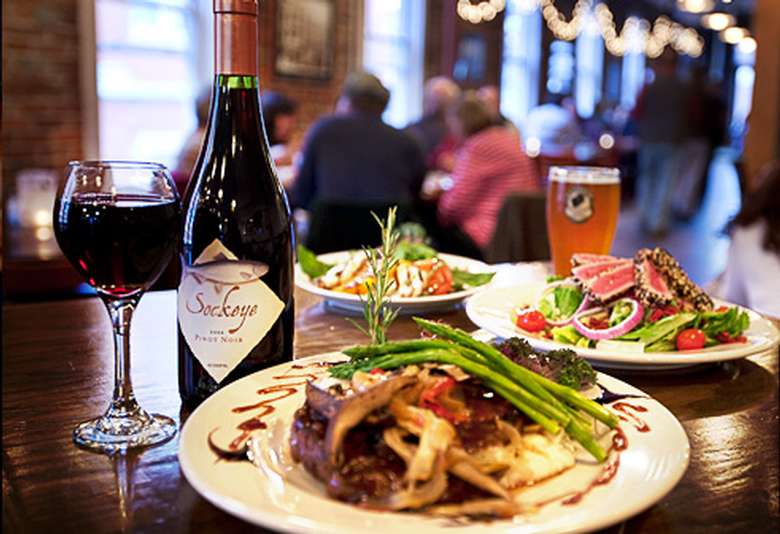 beer, wine, and plates of food on a table