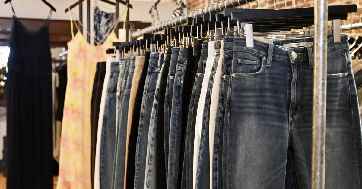 different styled jeans lined up on clothing rack