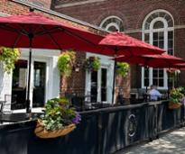 outdoor patio dining area at park 26 at queensbury hotel