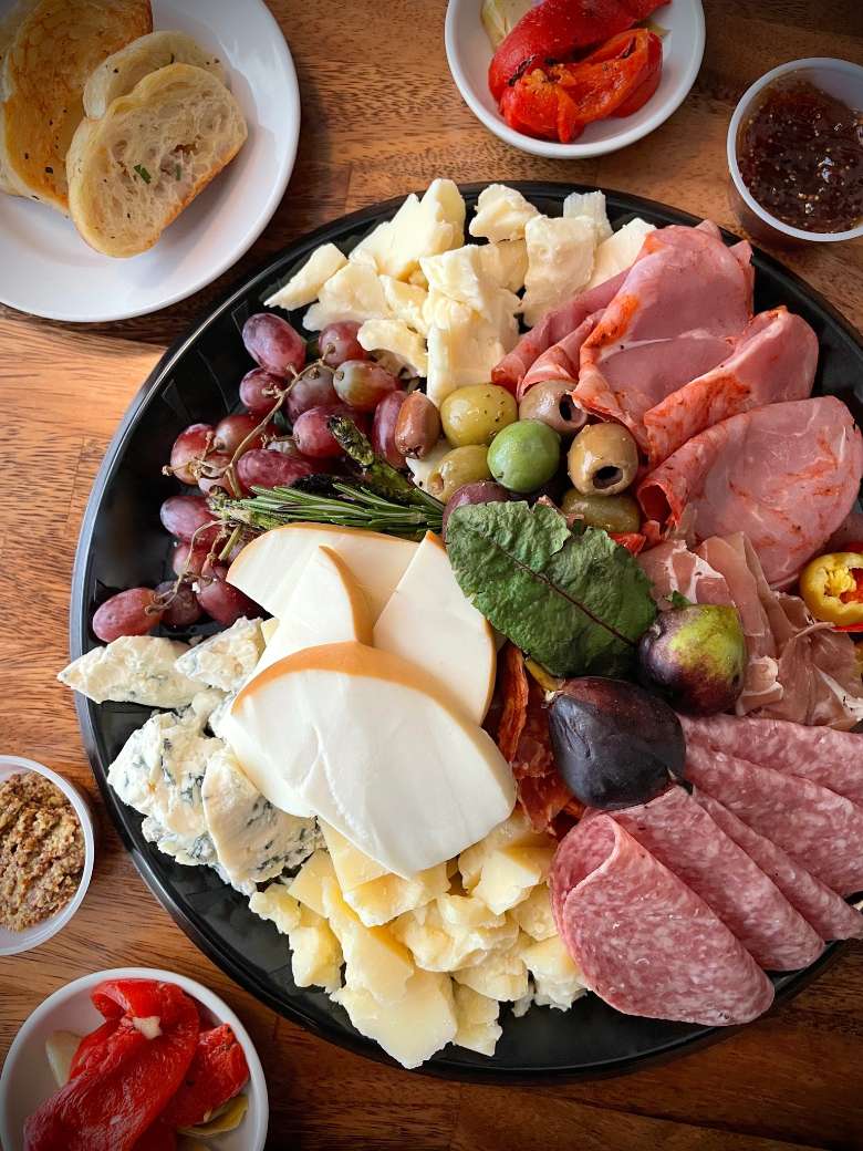 Entertaining? Let Park & Elm handle the cheeseboard and any other delicious catering offerings you might need. Cheese board with meats, olives, and bread