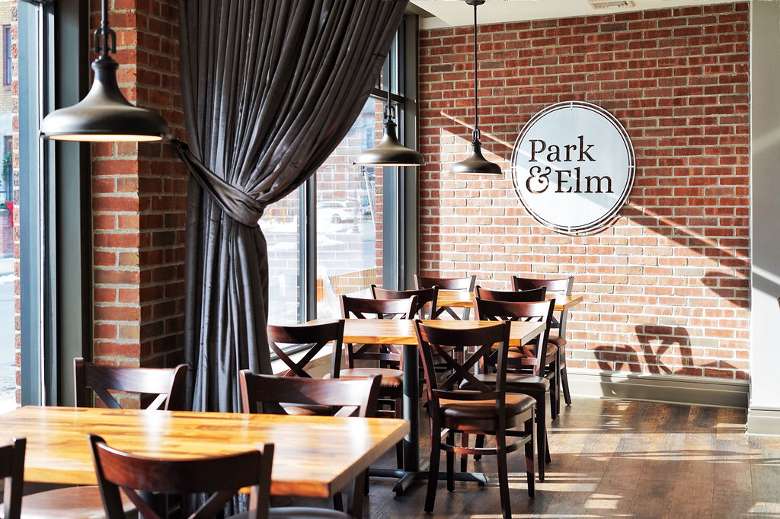 Visit their website for more info and plan a visit! seating in a restaurant with park & elm sign