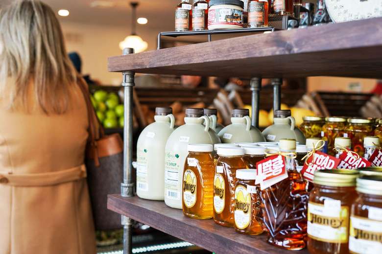 The restaurant specializes in seasonal, local ingredients, and the market keeps it local as well. honey and syrup in a store