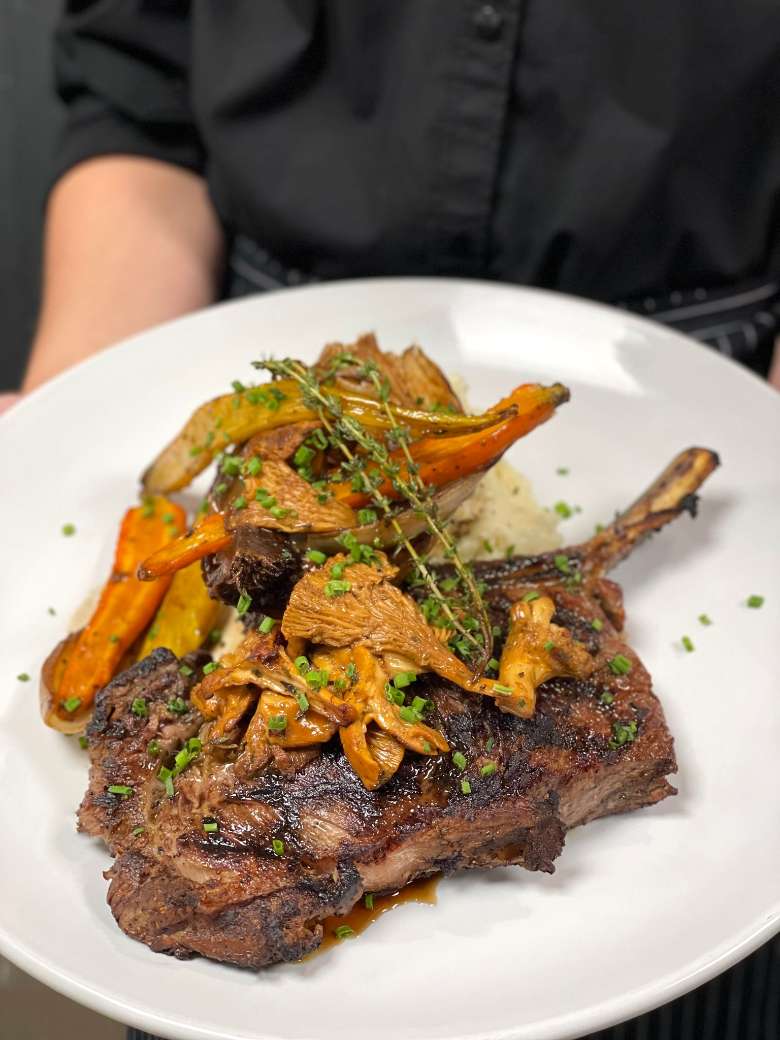 Explore delicious seasonal features on their innovative menu. Bone in ribeye with carrots