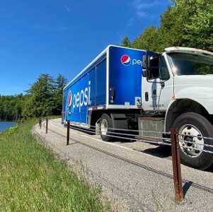 pepsi truck driving on a road