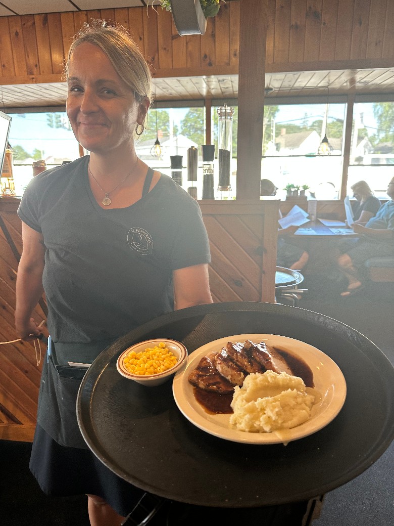 smiling server with tray of food