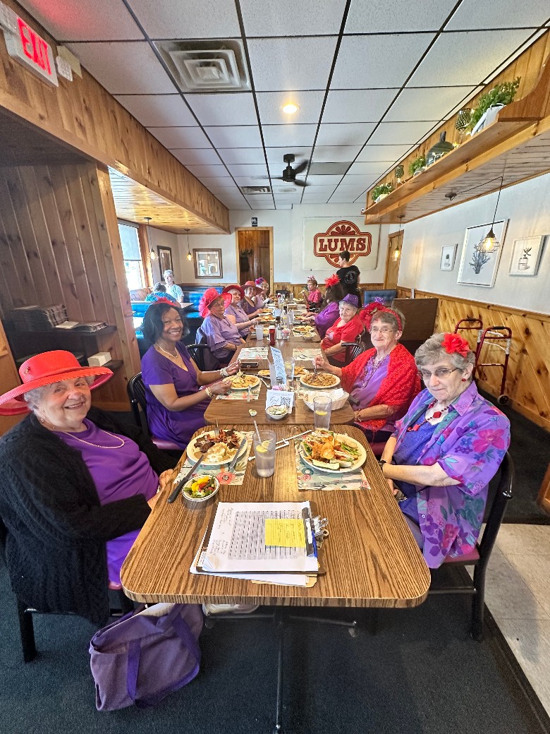 women at restaurant table, the red hat ladies