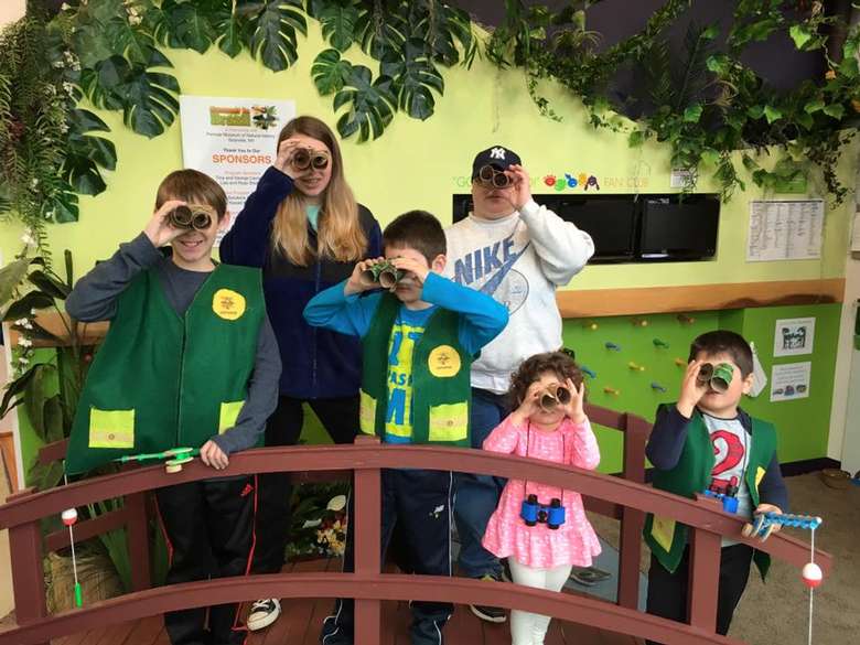 six kids looking through binoculars made out of toilet paper tubes