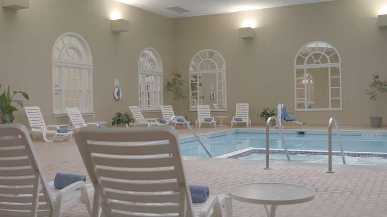 hotel pool area with lounge chairs