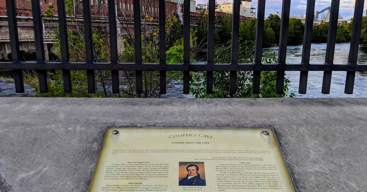 history marker by water and caves