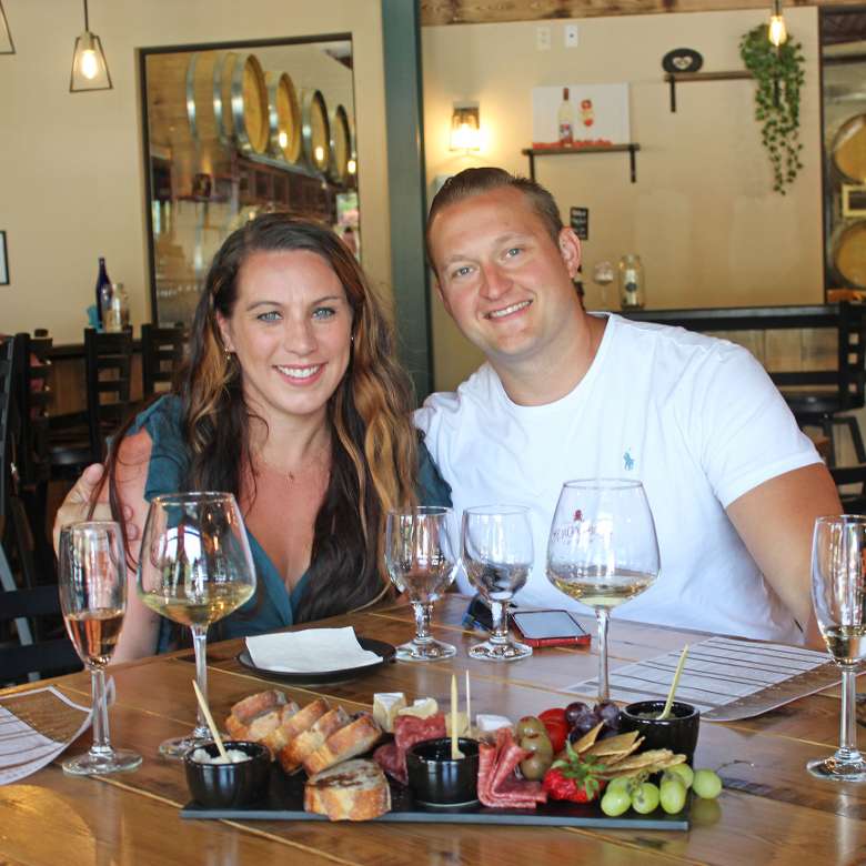 Offerings include wine-infused cheese bread, crackers, chocolates, fruits, and more to make a full meal or enjoy as a snack. couple at winery