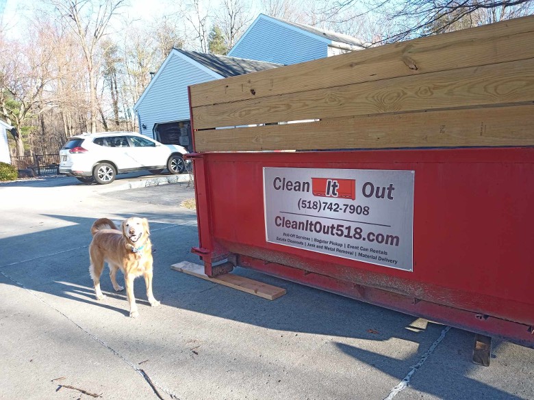 Brew the dog posing with a 10 Yard Dumpster in Moreau