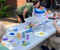 people paint rocks together
