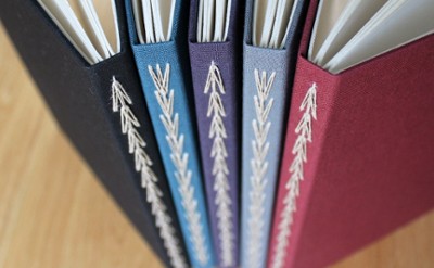 Bindings of 5 colorful books with sewing