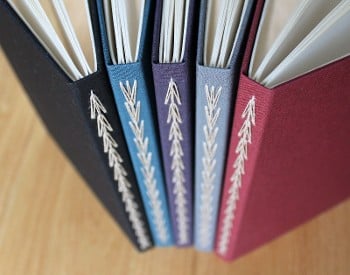 Bindings of 5 colorful books with sewing
